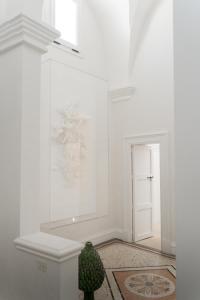 a room with white walls and a vase on the floor at Palazzo Maritati in Nardò