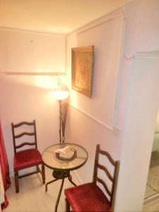 Habitación con mesa, 2 sillas y lámpara. en Aquedarte, en Lisboa