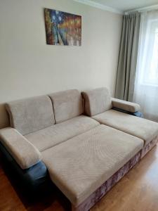 a couch sitting in a living room with at FourSpace in Ventspils