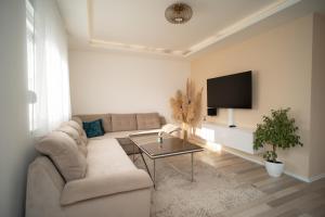 a living room with a couch and a tv at Skywalk House in Mostar