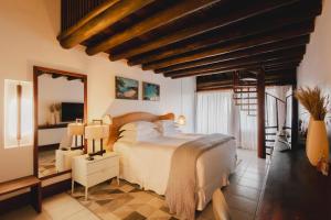 a bedroom with a large bed and a mirror at Pousada Maravilha in Fernando de Noronha +37 photos