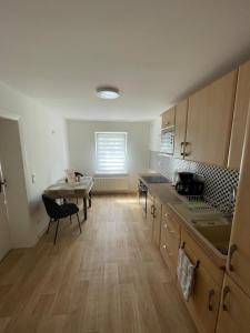 an empty kitchen with a table and a dining room at Trebelsee 2 Monteur- und Ferienwohnung in Ketzin