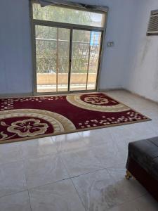 Zimmer mit einem großen Fenster und einem Teppich in der Unterkunft مسرة in Quai