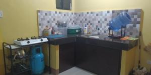 a kitchen with a counter top with a sink and a counter at House of DHESSA in Butuan +12 photos