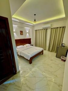 a bedroom with a bed and a television in it at King house hotel dahab in Dahab