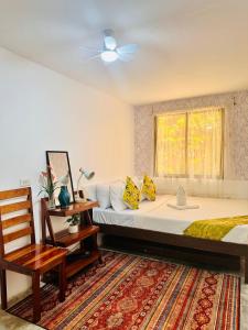 a bedroom with a large bed and a window at La Casita Feliz in Puerto Princesa City