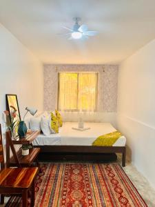 a bedroom with a bed and a window at La Casita Feliz in Puerto Princesa City