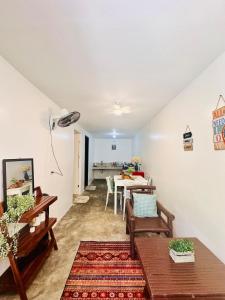 a living room with a table and a dining room at La Casita Feliz in Puerto Princesa City +23 photos