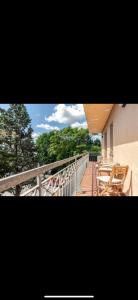 a deck with tables and chairs on a balcony at Appartamento sul Porto di Bellaria Igea Marina in Bellaria-Igea Marina