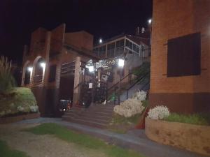 a building with stairs in front of a building at night at La Loma Resort in Merlo