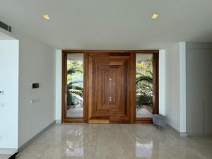 a large wooden door in a white room at Villa Lodos in Bodrum City +22 photos
