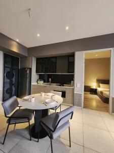 una cucina e una sala da pranzo con tavolo e sedie di Millerz Square Suite by Define Suite a Kuala Lumpur