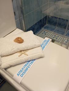 a pile of towels sitting on top of a toilet at Casa da Sogno Elegant Studio in Nafpaktos +125 photos