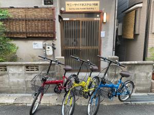 two bikes parked in front of a building at サニーサイドホステル1号館 in Uji