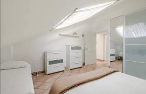 a white bedroom with a bed and white cabinets at Attico Vista Mare 50m dal centro in Bellaria-Igea Marina
