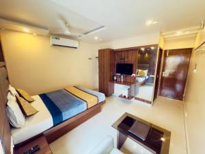 a bedroom with a bed and a desk and a mirror at The Hydel Park - Business Class Hotel - Near Central Railway Station in Chennai