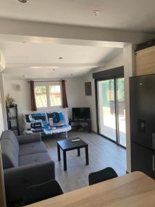 a living room with a couch and a table at GRIMAUD-Maison 4 Pers - Piscine in Grimaud