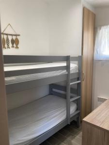 a bunk bed room with two bunk beds at GRIMAUD-Maison 4 Pers - Piscine in Grimaud +4 photos