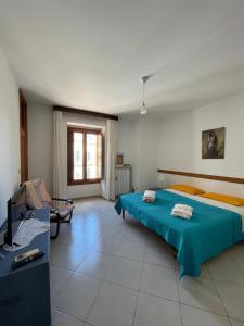 a bedroom with a bed and a tv in it at Dimora alla Villa in Ostuni