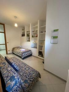 a room with two beds and shelves in it at Dimora alla Villa in Ostuni