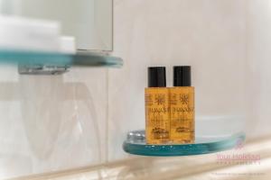 a bottle ofmanent makeup on a glass shelf at Your Holidays Campingowa in Międzyzdroje +16 photos