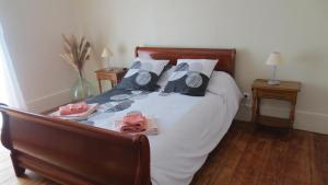 a bedroom with a bed with white sheets and pillows at Au petit moulin in Issigeac