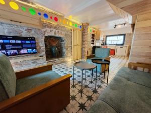 a living room with a couch and a fireplace at Meli Mila Spiti milozrooms Ayvalik in Ayvalık