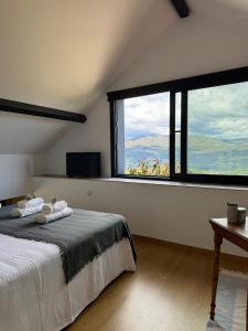 a bedroom with a bed and a large window at Quinta da Lembrança in Arcos de Valdevez +76 photos