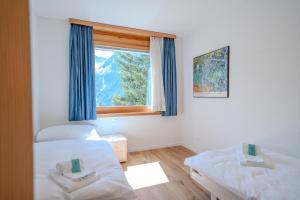 Postel nebo postele na pokoji v ubytování Casa Cresta C32 by Arosa Vacations