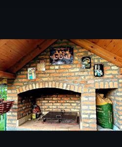 a brick fireplace with a bench in front of it at Hopovske Terase in Irig