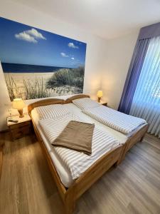 a bedroom with a bed with a view of the beach at Ferienhaus Blinkfuer in Neuharlingersiel