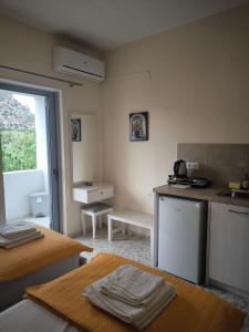 a kitchen with a sink and a counter top at Alexia Rooms in Palaiochora +45 photos
