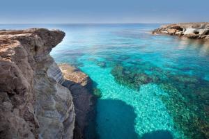 an aerial view of the ocean from a cliff at paphos pool view gem - cozy 1 bed Apartment in Paphos