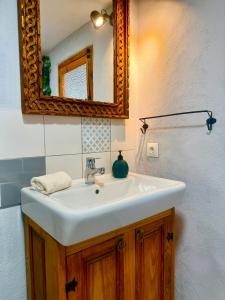 a bathroom with a white sink and a mirror at Casa Mona- Andalucian mountain village getaway in Güéjar-Sierra +43 photos