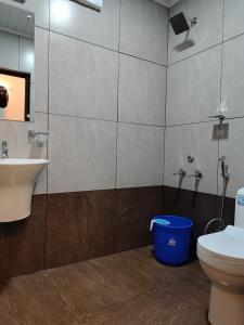 a bathroom with a toilet and a sink at Birdwing Cottage, Munnar in Munnar