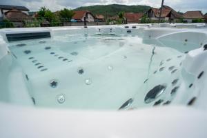 a hot tub on top of a house at Gold Residence in Ocna-Mureşului