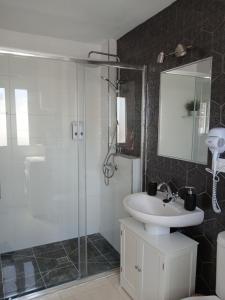 a bathroom with a sink and a shower with a mirror at Villa Yissa en Prado Del Rey, Cádiz con WIFI in Prado del Rey