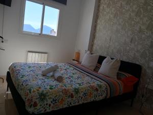 a bedroom with a large bed with a colorful blanket at Villa Yissa en Prado Del Rey, Cádiz con WIFI in Prado del Rey