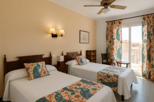 a hotel room with two beds and a window at Mallorca Boutique Hotel in Malgrat de Mar