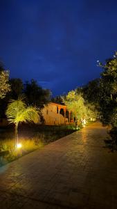 a park at night with a building and trees at Rida Village Ksamil Island in Ksamil