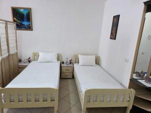 a room with two beds in a room at Volga Cozy Apartment in Durrës