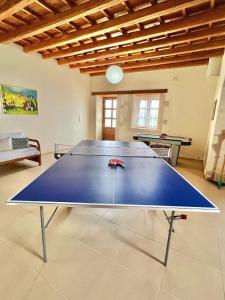 a ping pong table in the middle of a room at Arodamos Villa with a pool, children's games, and BBQ, perfect for 23 people! in Skouloúfia +80 photos