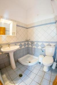 a bathroom with a toilet and a sink at Angelonia Studios Sidari in Sidari