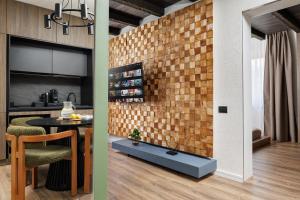 a kitchen and dining room with a brick wall at Mountain View Chalet - Poiana Brasov in Braşov