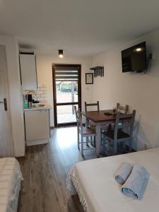 a room with a table and a kitchen with a table and chairs at Krutyńska Sielanka in Piecki +28 photos