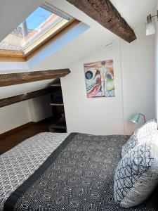 a bedroom with a bed and a window at Nid au pied du Mont Caroux in Le Poujol-sur-Orb