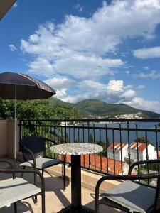 a table and chairs on a balcony with a view of the water at Seaview apartment Bava in Zaton +18 photos