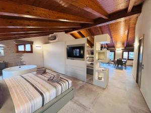 a bedroom with a bed and a sink and a tv at L'Appoggio in Fondi