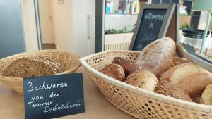 two baskets of different types of bread on a table at B&B Beyond in Nittel