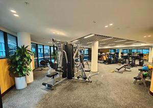 a gym with several treadmills and exercise equipment at Brand new 1B apartment in Woden near Hospital Westfield and pool gym in Phillip